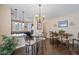 Bright dining area with a view of the kitchen, featuring elegant lighting and a cozy atmosphere at 15646 N 20Th Ave, Phoenix, AZ 85023