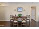 Elegant dining room with wood floors, a modern table set, and decorative wall art at 15646 N 20Th Ave, Phoenix, AZ 85023