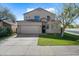 Charming two-story home showcasing a well-manicured lawn and a two-car garage at 15646 N 20Th Ave, Phoenix, AZ 85023