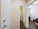 Hallway featuring doors to the bathroom and laundry room, with wood-look flooring at 15646 N 20Th Ave, Phoenix, AZ 85023