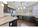 Modern kitchen featuring dark cabinets, granite countertops, and stainless steel appliances at 15646 N 20Th Ave, Phoenix, AZ 85023