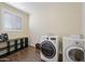 Well-organized laundry room with modern washer and dryer units and a convenient folding area at 15646 N 20Th Ave, Phoenix, AZ 85023