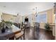 Open living and dining area with bar seating, hardwood floors, neutral walls, and recessed lighting at 15646 N 20Th Ave, Phoenix, AZ 85023