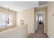 Upstairs hallway featuring a light fixture and an open doorway to the primary bedroom at 15646 N 20Th Ave, Phoenix, AZ 85023