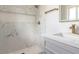 Modern tiled shower and vanity area in a renovated bathroom at 1610 W Dunlap Ave, Phoenix, AZ 85021