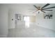 Open-concept living room with marble floors, a modern ceiling fan, and access to the kitchen at 1610 W Dunlap Ave, Phoenix, AZ 85021