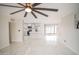 Spacious living room with marble floors, a modern ceiling fan, and an open layout at 1610 W Dunlap Ave, Phoenix, AZ 85021