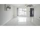 Bright living room with marble floors, a modern ceiling fan, and a large window at 1610 W Dunlap Ave, Phoenix, AZ 85021