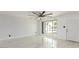 Bright living room with marble floors, large window, and a modern ceiling fan at 1610 W Dunlap Ave, Phoenix, AZ 85021