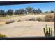 Backyard view showcasing desert landscaping and views of a lush green golf course at 17200 W Bell Rd # 2301, Surprise, AZ 85374