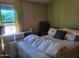 Calm bedroom with a comfortable bed, neutral colors, and bright natural light at 17200 W Bell Rd # 2301, Surprise, AZ 85374