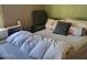 Bedroom featuring a comfortable bed with a green armchair and natural light at 17200 W Bell Rd # 2301, Surprise, AZ 85374