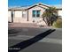 Exterior front view of home featuring neutral paint, walkway, palm trees and desert landscaping at 17200 W Bell Rd # 2301, Surprise, AZ 85374