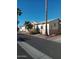 Street view of tan homes with palm trees and desert landscaping at 17200 W Bell Rd # 2301, Surprise, AZ 85374