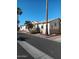 Street view of tan homes with palm trees and desert landscaping at 17200 W Bell Rd # 2301, Surprise, AZ 85374