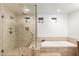 Modern bathroom featuring a glass-enclosed shower and a soaking tub with tiled surround at 1801 E Berridge Ln, Phoenix, AZ 85016