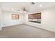 Bright and airy bedroom with neutral carpet, ceiling fan, and views from windows with wooden blinds at 1801 E Berridge Ln, Phoenix, AZ 85016