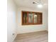 Well-lit bedroom with wood-look flooring, a ceiling fan, and a window with wooden shutters at 1801 E Berridge Ln, Phoenix, AZ 85016