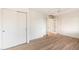 Bedroom with ample natural light, light wood-look flooring, a ceiling fan and closet with sliding doors at 1801 E Berridge Ln, Phoenix, AZ 85016