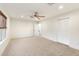 Bedroom features ceiling fan, closet with louvered doors, neutral carpet, and natural light at 1801 E Berridge Ln, Phoenix, AZ 85016