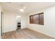 Inviting bedroom with wood-look flooring, a ceiling fan, and a window, plus an ensuite bathroom view at 1801 E Berridge Ln, Phoenix, AZ 85016