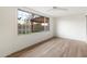 Light-filled bedroom with ceiling fan and large window offering backyard views at 1801 E Berridge Ln, Phoenix, AZ 85016