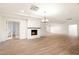 Open living room featuring wood-look flooring, fireplace, recessed lighting, and French doors at 1801 E Berridge Ln, Phoenix, AZ 85016