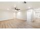 Spacious living room featuring modern ceiling fan, recessed lighting, and light wood-look flooring at 1801 E Berridge Ln, Phoenix, AZ 85016