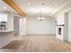 Open-concept living space featuring hardwood floors, a modern fireplace, and exposed beam architecture at 1801 E Berridge Ln, Phoenix, AZ 85016