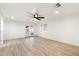 Open living room featuring light wood-look flooring, recessed lighting, ceiling fan and glass patio doors at 1801 E Berridge Ln, Phoenix, AZ 85016