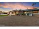 Rear view of the home showing a large, low-maintenance desert landscape at 1801 E Berridge Ln, Phoenix, AZ 85016