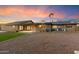 View of the house with a desert landscape and covered patio, perfect for outdoor entertaining and enjoying the Arizona sunsets at 1801 E Berridge Ln, Phoenix, AZ 85016