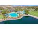 Community amenities includes a spacious pools and a lake with surrounding palm trees and greenery at 18601 W Thunderhill Pl, Goodyear, AZ 85338