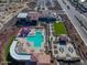 Aerial view of the community pool featuring a splash pad, seating, landscaping, and parking at 18601 W Thunderhill Pl, Goodyear, AZ 85338