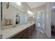 Bathroom featuring dual sinks with a view of the shower and bedroom at 18601 W Thunderhill Pl, Goodyear, AZ 85338