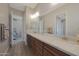 Bathroom featuring dual sinks and a large mirror for lots of counter space at 18601 W Thunderhill Pl, Goodyear, AZ 85338