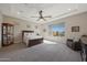 Spacious bedroom with large windows, ceiling fan and neutral decor for a serene retreat at 18601 W Thunderhill Pl, Goodyear, AZ 85338