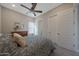 Bedroom with a wooden dresser, large window, and ceiling fan at 18601 W Thunderhill Pl, Goodyear, AZ 85338