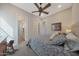 Cozy bedroom with a rocking horse, ceiling fan, and soft carpet at 18601 W Thunderhill Pl, Goodyear, AZ 85338