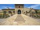 Inviting entrance to the community building with stone archway and tiled pathway at 18601 W Thunderhill Pl, Goodyear, AZ 85338