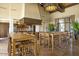 Community kitchen area with tables, chairs, stainless steel appliances, and ample lighting at 18601 W Thunderhill Pl, Goodyear, AZ 85338