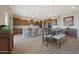 Dining area and kitchen with hardwood floors, stainless steel appliances, and ample cabinet space at 18601 W Thunderhill Pl, Goodyear, AZ 85338