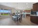 Bright dining area featuring a modern chandelier and open floor plan at 18601 W Thunderhill Pl, Goodyear, AZ 85338