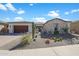 Beautiful single-story home featuring a stone exterior, desert landscaping, and a two-car garage at 18601 W Thunderhill Pl, Goodyear, AZ 85338