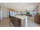 Open kitchen and living area boasts stainless appliances and a modern aesthetic at 18601 W Thunderhill Pl, Goodyear, AZ 85338