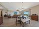 Open-concept living room and dining area with wood floors and lots of natural light at 18601 W Thunderhill Pl, Goodyear, AZ 85338