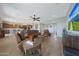 Airy living room with hardwood floors, ample seating, and open layout to the kitchen at 18601 W Thunderhill Pl, Goodyear, AZ 85338