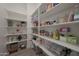 Walk-in pantry with floor-to-ceiling shelving for ample storage space at 18601 W Thunderhill Pl, Goodyear, AZ 85338