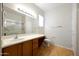 Bright bathroom featuring a long vanity with a sink, a toilet, and a glass shower at 19602 N Canyon Whisper Dr, Surprise, AZ 85387