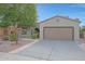 Charming single-story home featuring a two-car garage and desert landscaping at 19602 N Canyon Whisper Dr, Surprise, AZ 85387